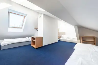 a bedroom with two beds and a blue dresser at Family Apartments Praha 6 in Prague
