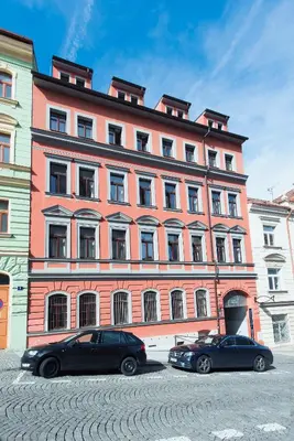a bedroom with a bed and a couch at Family Apartments Praha 6 in Prague
