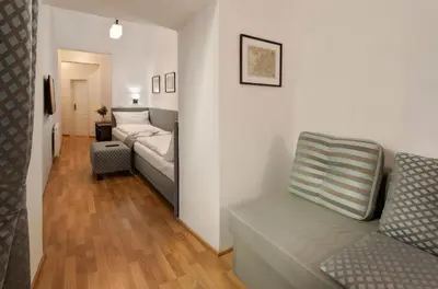 a living room with a couch and a chair at Residence Corto Old Town in Prague
