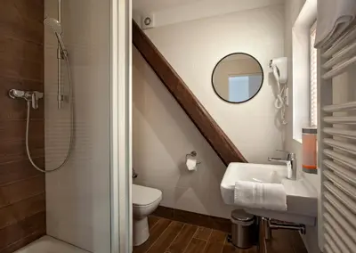 a bathroom with a sink and a toilet and a staircase at Residence Corto Old Town in Prague