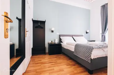 a bedroom with a bed and a wooden floor at Residence Corto Old Town in Prague