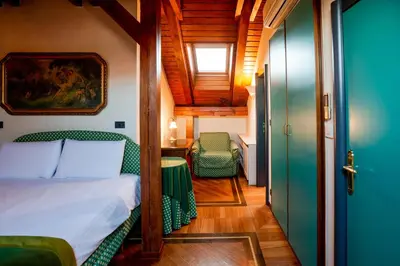 a bedroom with a bed and a table and a chair at Residence Jecna in Prague