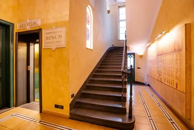 a staircase in a building with yellow walls at Residence Jecna in Prague