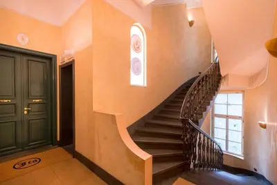 a staircase in a house with a black door at Residence Jecna in Prague