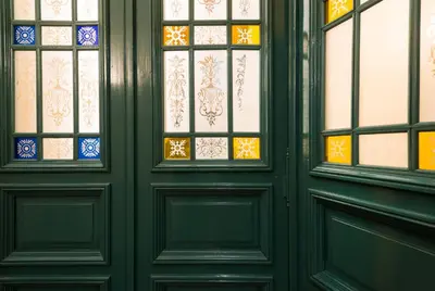 a pair of doors with stained glass at Residence Jecna in Prague