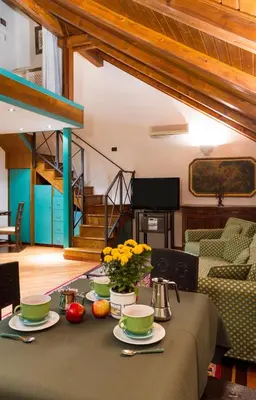 a table with a green table cloth and flowers on it at Residence Jecna in Prague