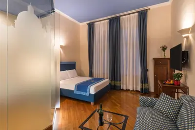 a hotel room with a bed and a couch at Residence Jecna in Prague