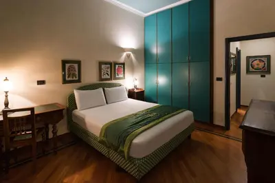 a bedroom with a bed and a blue cabinet at Residence Jecna in Prague