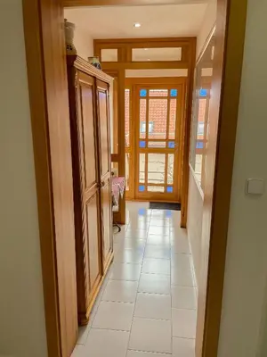 a hallway of a house with a door and a tile floor at Ubytování Kubantovi in Prague