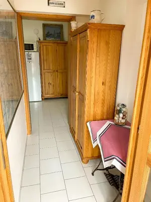 a small kitchen with a table and a refrigerator at Ubytování Kubantovi in Prague