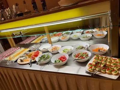 a buffet line with many plates of food and appetizers at Hotel Askania in Prague