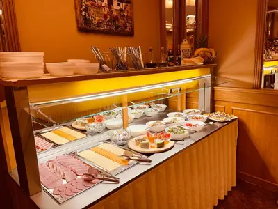 a buffet line with meats and cheese and other foods at Hotel Askania in Prague