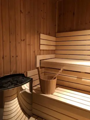 a sauna with a tub and a bucket in it at Hotel Askania in Prague