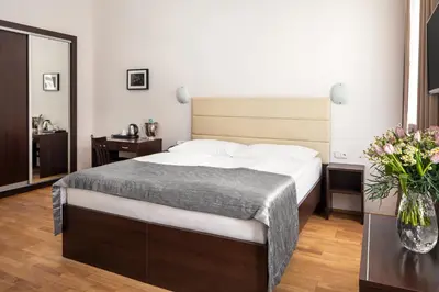 a bedroom with a bed and a vase of flowers at Hotel Unique in Prague