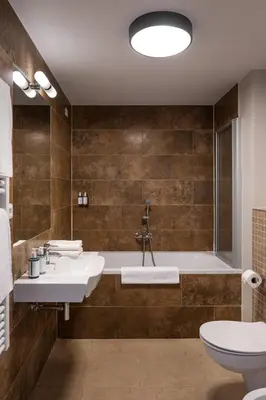 a bathroom with two sinks and a bath tub at Hotel Unique in Prague