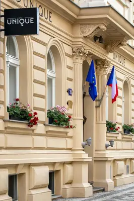 a building with two flags and flowers on it at Hotel Unique in Prague