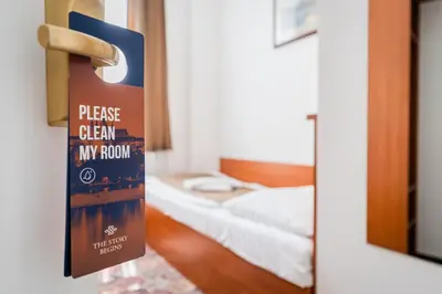 a sign on the door of a room with a bed at City Centre in Prague