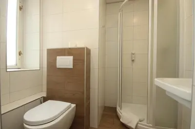 a bathroom with a toilet and a shower and a sink at City Centre in Prague