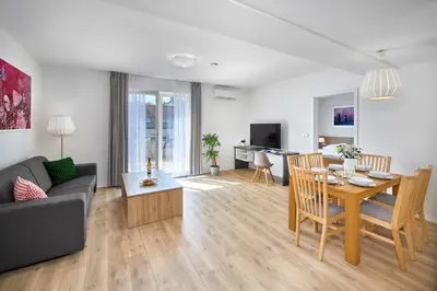 a living room with a couch and a table at DownTown Suites Belohorska in Prague