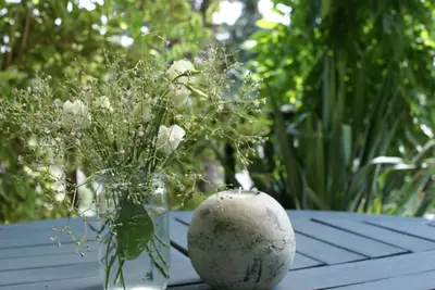 a vase with flowers in it sitting on a table at Villa Letná in Brandýs nad Labem-Stará Boleslav