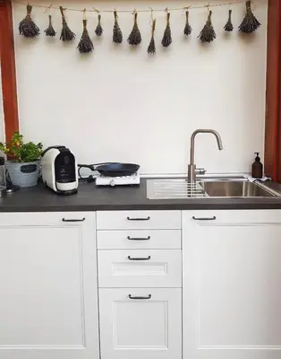 a kitchen with white cabinets and a sink and a counter at Villa Letná in Brandýs nad Labem-Stará Boleslav