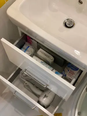 an open drawer in a bathroom sink at Homelike Prague Apartment in Prague