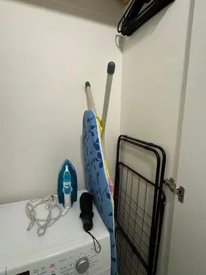 two baseball equipment sitting on top of a refrigerator at Homelike Prague Apartment in Prague