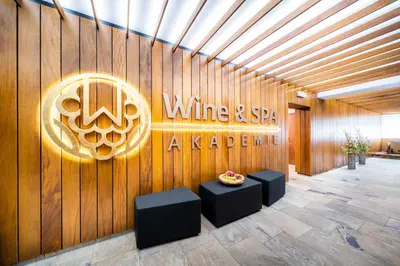 a wine and sip activation sign on a wooden wall at Hotel Akademie in Chocerady