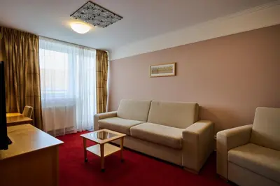 a living room with a couch and a table at Hotel Akademie in Chocerady