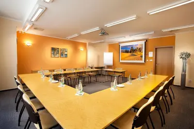 a large conference room with a long table and chairs at Hotel Akademie in Chocerady
