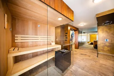 a sauna with wood paneling and a glass wall at Hotel Akademie in Chocerady