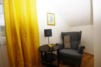 a room with a chair and a table and a window at Cozy Gardens Apartments in Prague in Prague