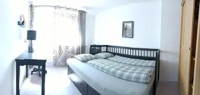 a bedroom with a bed and a table and a window at Cozy Gardens Apartments in Prague in Prague