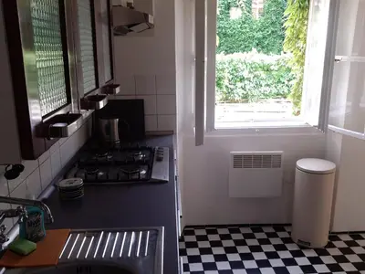 a kitchen with a stove and a window and a checkered floor at Old Town Magical place in Prague