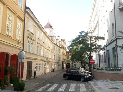 a black car parked on a street with buildings at Old Town Magical place in Prague