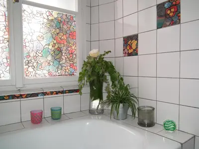 a bathroom with a bath tub with a vase with a flower at Old Town Magical place in Prague