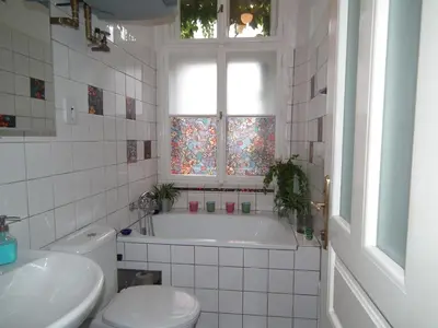 a bathroom with a tub and a toilet and a window at Old Town Magical place in Prague
