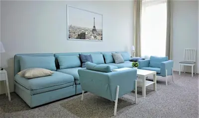 a blue couch and chairs in a living room at Aparthotel Wenceslas in Prague