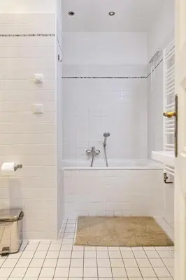 a white bathroom with a tub and a sink at Aparthotel Wenceslas in Prague