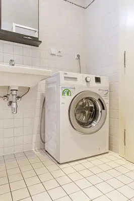 a washing machine in a bathroom next to a sink at Aparthotel Wenceslas in Prague