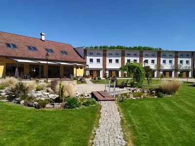 a garden with a pond in front of a building at Statek 1738 in Všestudy
