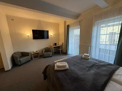 a bedroom with a bed and a flat screen tv at Statek 1738 in Všestudy