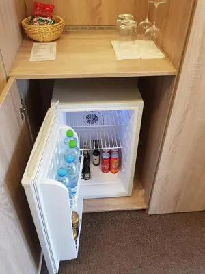 a small refrigerator with drinks in it in a cabinet at Statek 1738 in Všestudy