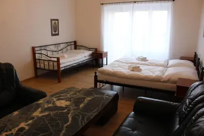 a living room with two beds and a couch at Hotel Černý kůň in Louny