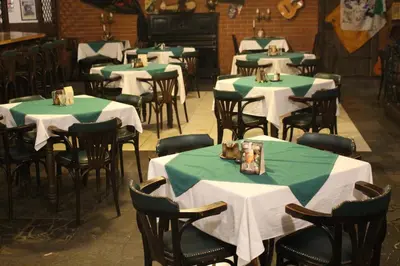 a dining room with green and white tables and chairs at Hotel Černý kůň in Louny