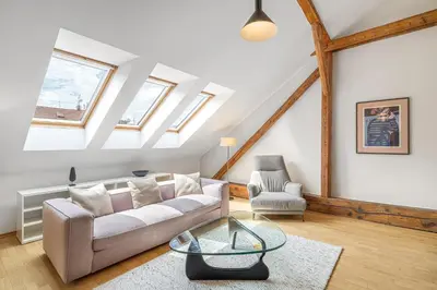 a living room with a couch and a table at Hunger Wall Residence in Prague