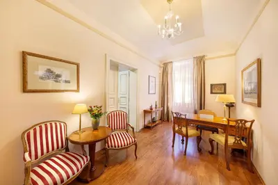 a living room with a dining room table and chairs at Hunger Wall Residence in Prague