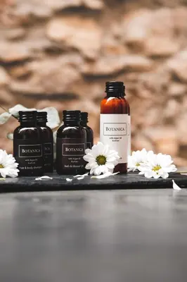 a group of three bottles of honey and white flowers at Hunger Wall Residence in Prague