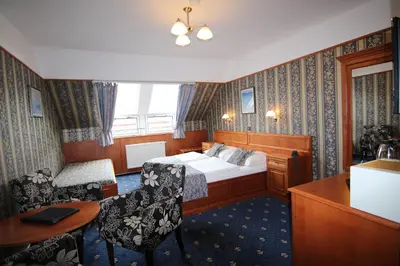 a hotel room with a bed and a desk at Old Prague Hotel in Prague