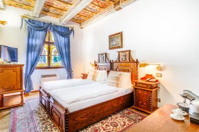 a bedroom with a large bed and a window at The King Charles in Prague